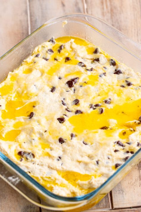 Biscuit dough and butter in a baking dish.