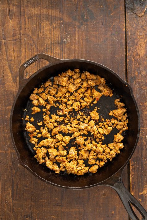 Sausage cooking in a skillet.