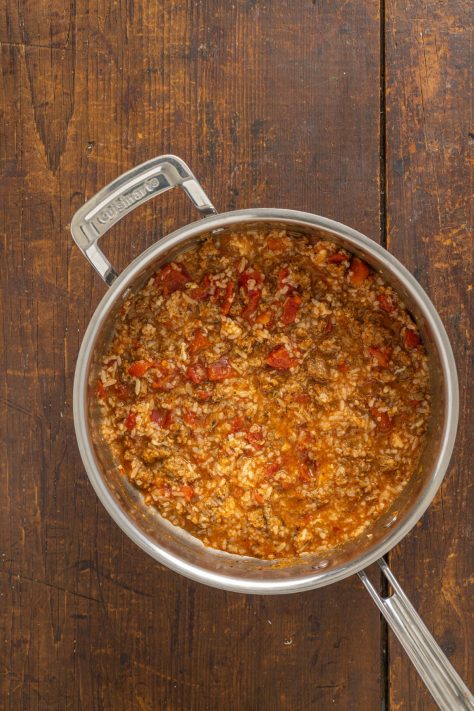 Stuffed peppers filling in a skillet.