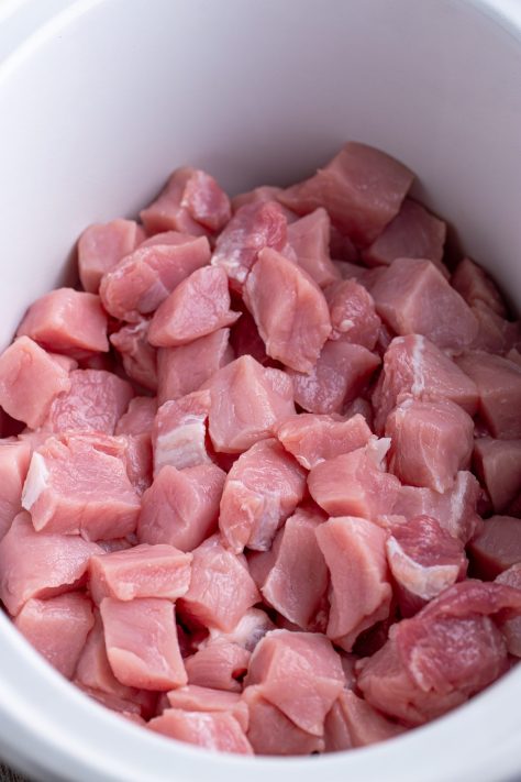 Raw pork bites in a Slow Cooker.