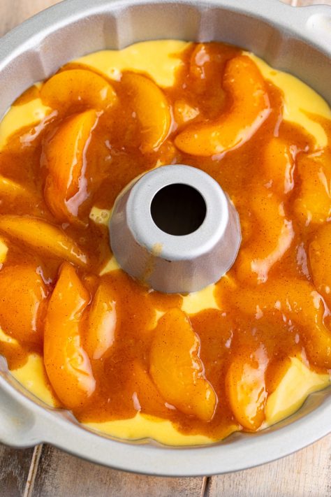 Peaches on top of cake batter.