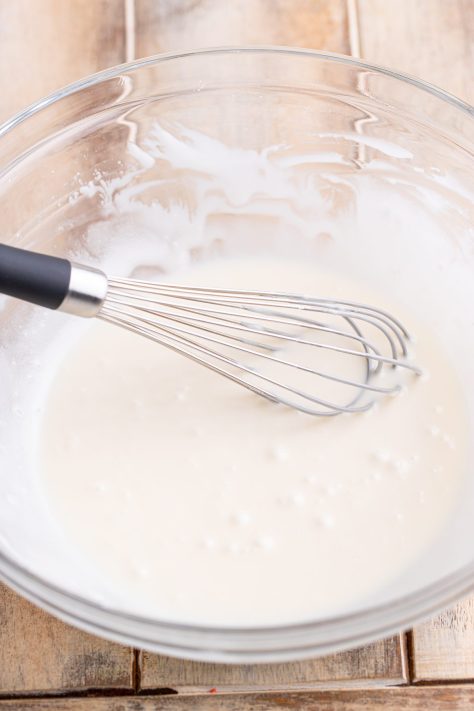 Powdered milk, sugar, and vanilla being whisked in the bowl.