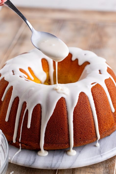 Glaze being drizzled over the cake.