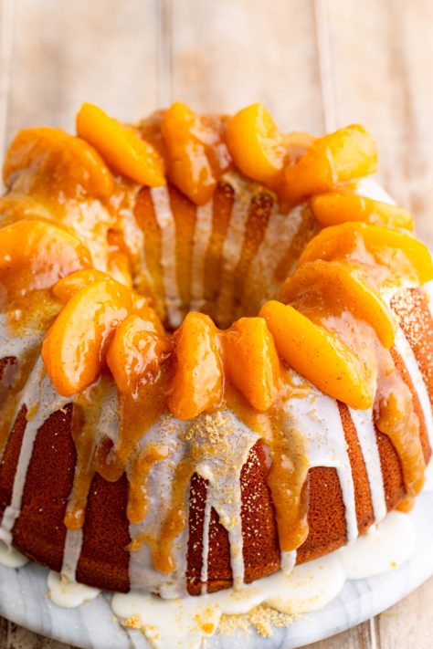 Peaches with brown sugar, and glaze over a cake.