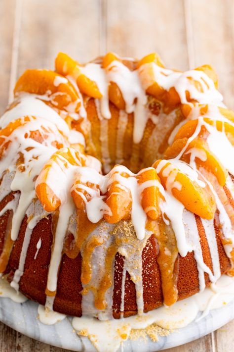 Glaze and brown sugar with peaches over a peach cobbler pound cake.