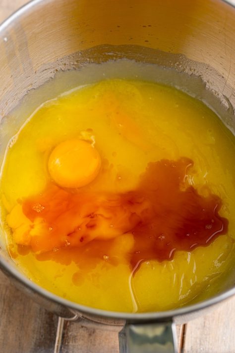 Eggs and vanilla extract being added to cake batter.