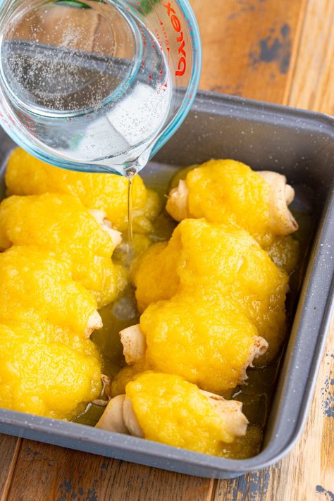Soda being poured over crescent rolls with pears.