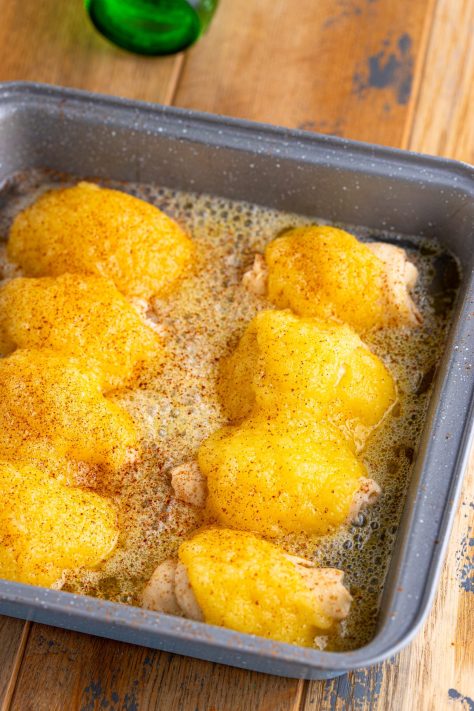 Cinnamon being sprinkled over unbaked Pear Dumplings.