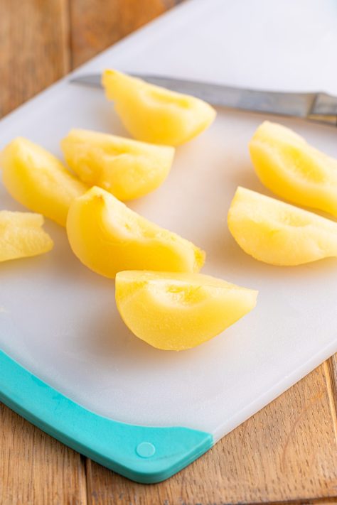 Pears being cut on a cutting board.