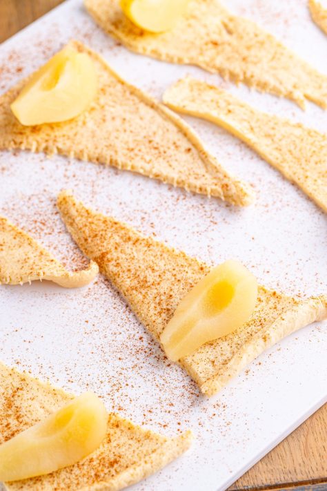 Pears and cinnamon on crescent roll dough.