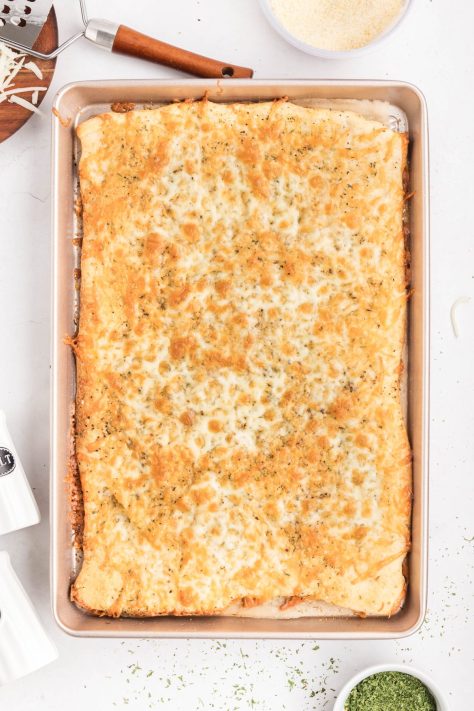 Baked Pizza Dough Garlic Cheese Bread waiting to be sliced.