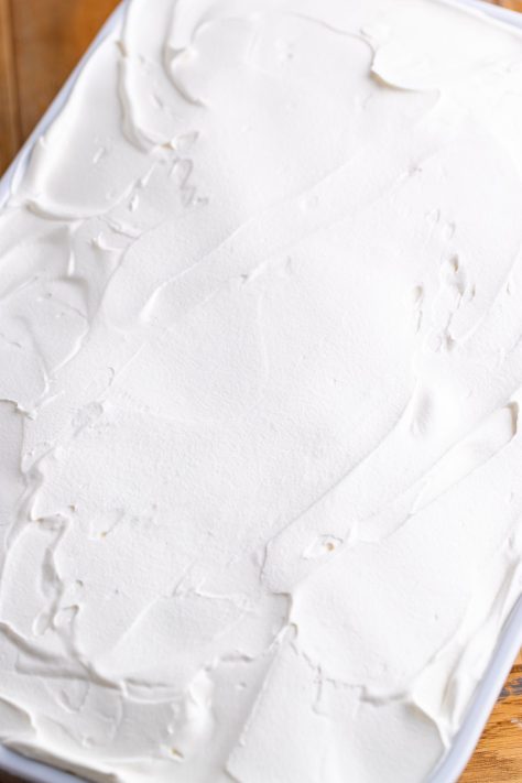 More Cool Whip on top of a layered dessert.