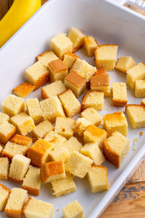 Cubed pound cake in a baking dish.