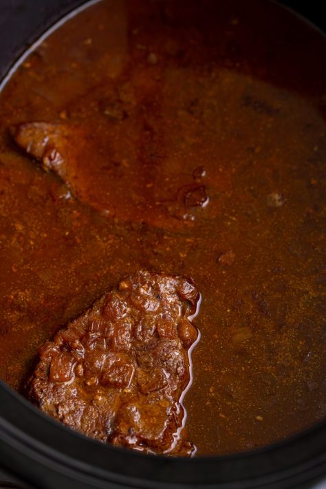 Cooked Steak and Gravy in a Crock Pot.