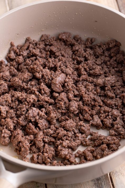 Cooked ground beef in a skillet.