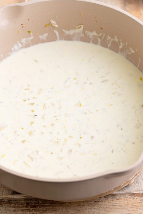 Cream sauce being made in a skillet.