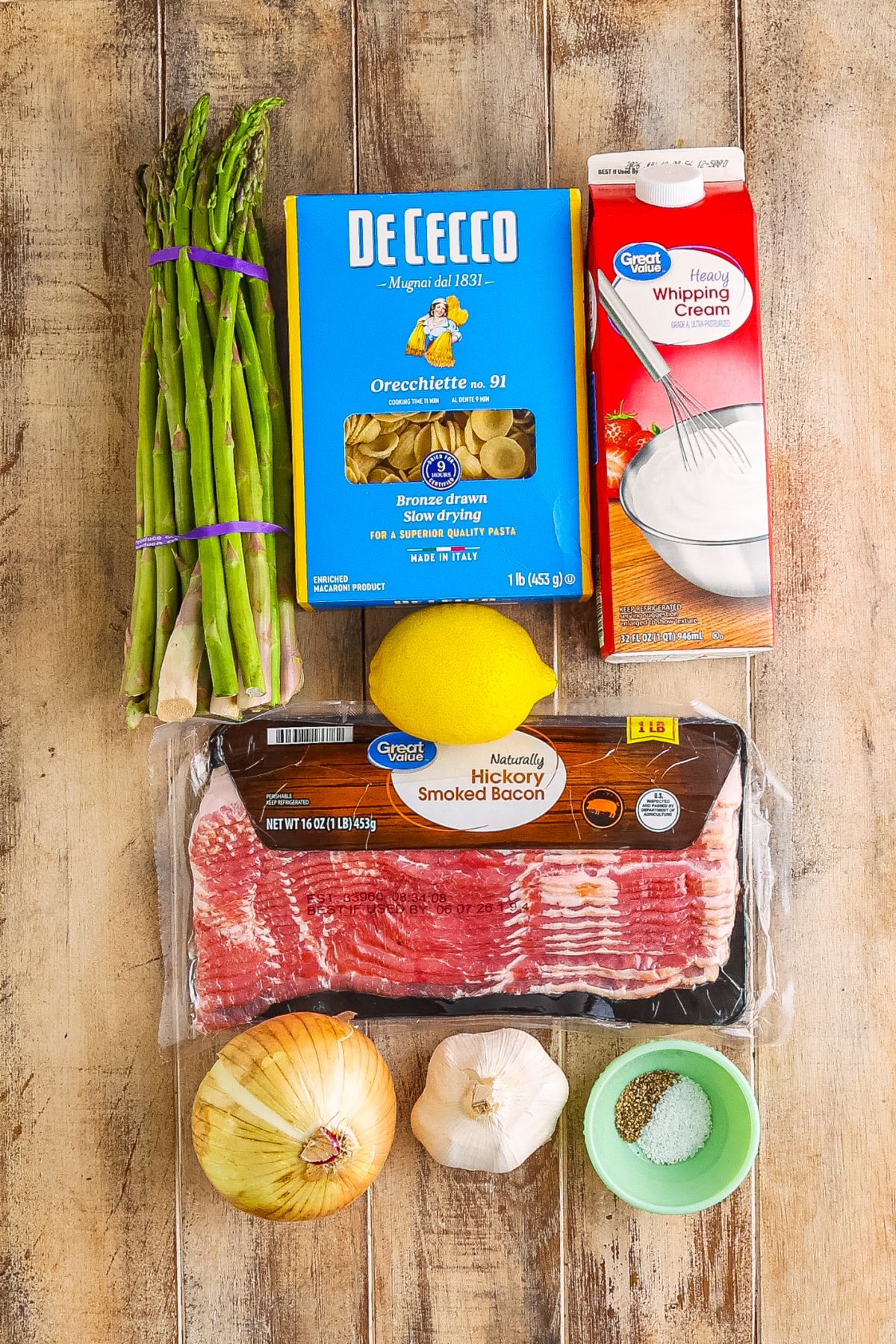 Bacon, sweet onion, garlic, orecchiette pasta, asparagus, heavy cream, lemon juice, lemon zest, kosher salt, black pepper, reserved pasta water, and grated Parmesan cheese.