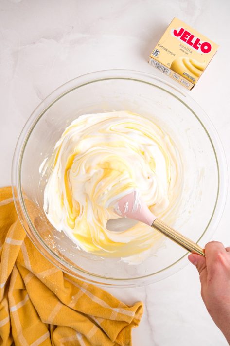 Cool Whip being mixed into a pudding mixture.