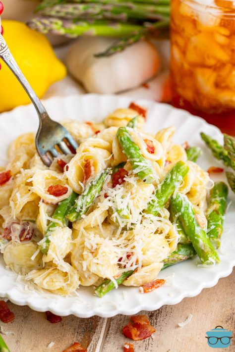 A fork in a serving of Asparagus Pasta on a plate.