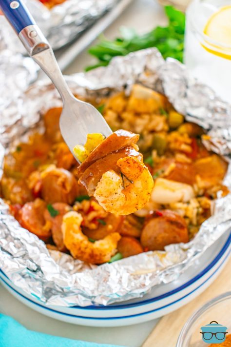 A fork getting a bite of Baked Jambalaya Foil Packets.