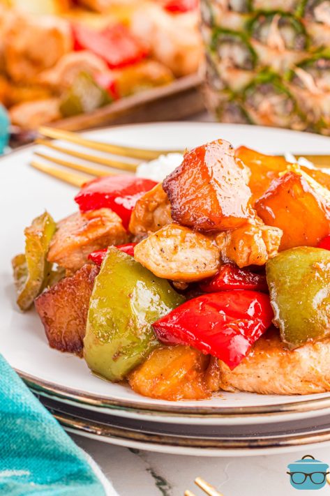 A dinner plate with a large scoop of Hawaiian Chicken Sheet Pan Meal.