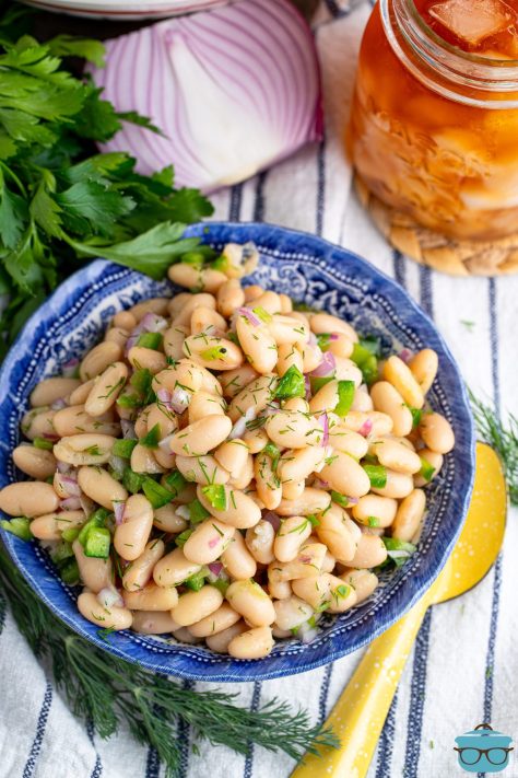 Looking down on a bowl of White Bean Salad with dill.