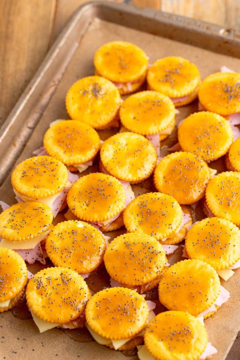 Poppy seeds sprinkled over cracker sandwiches.