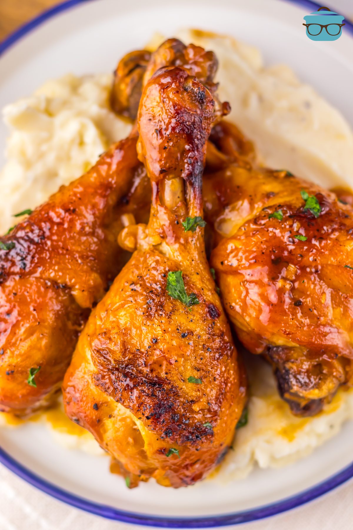 A few Crock Pot Cherry Coke Drumsticks on a bed of mashed potatoes.