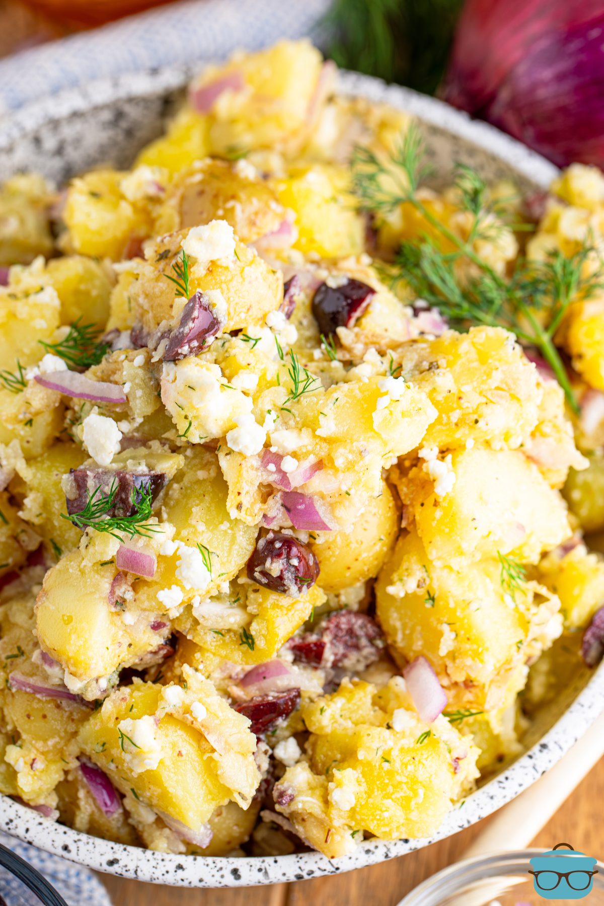 A large serving of Greek Potato Salad in a bowl.