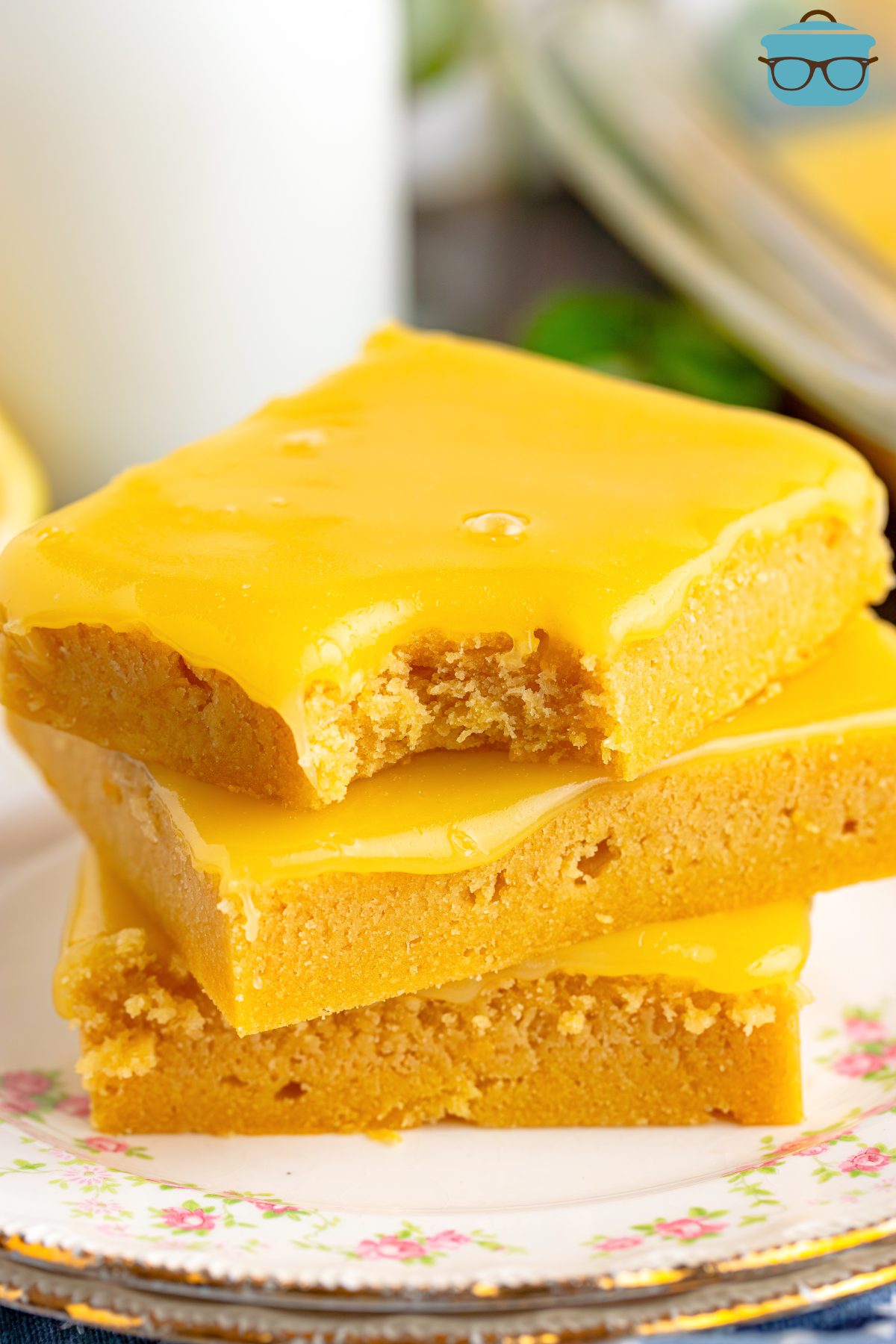 A small stack of Lemon Cookie Bars with the top one missing a bite.