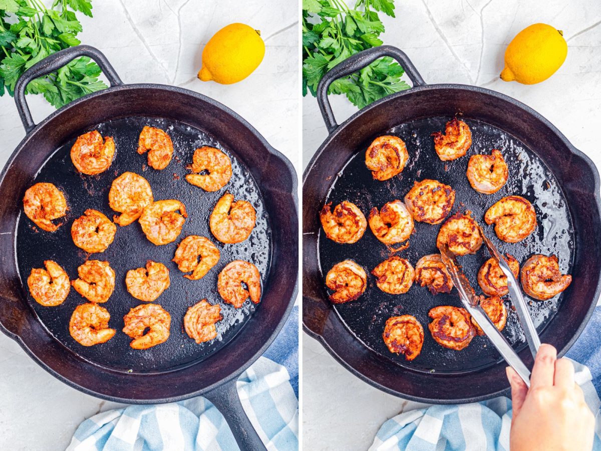 A cast iron skillet cooking shrimp and a hand flipping some shrimp with tongs. 