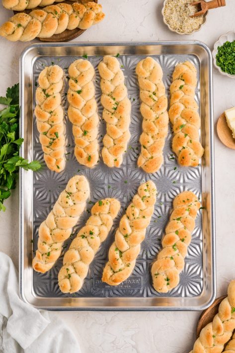 A sheet pan with baked Braided Breadsticks.
