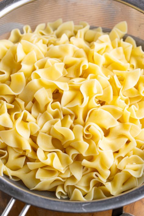 Noodles draining in a strainer.
