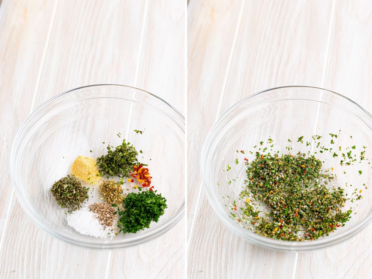 A glass bowl with parsley, basil, rosemary, oregano, garlic powder, salt, pepper, and chili flakes all mixed together.