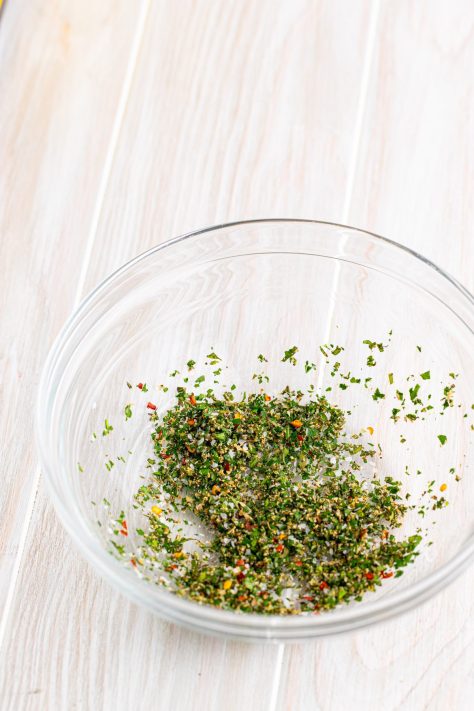 A plate of mixed up herbs and seasonings.
