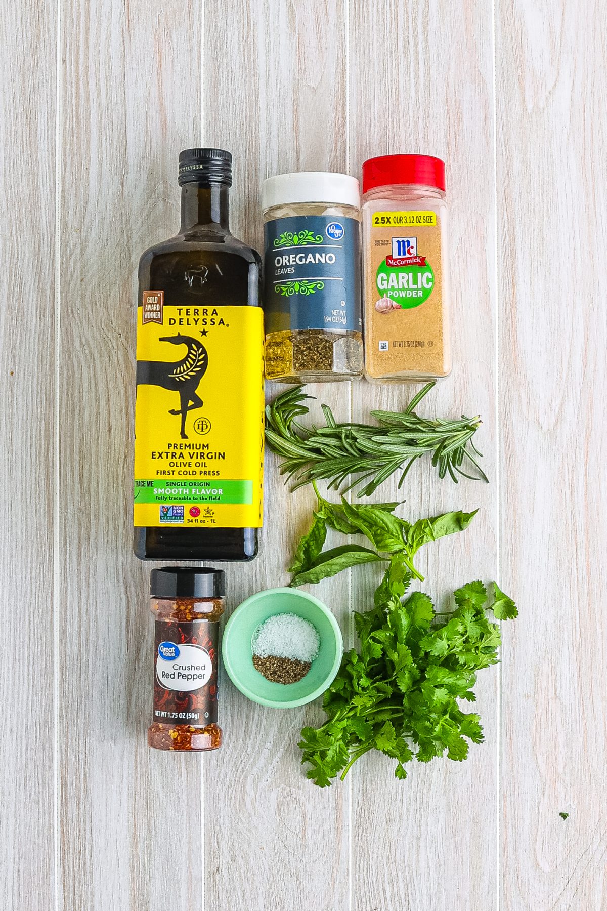 Fresh Italian parsley, fresh basil, fresh rosemary, dried oregano, garlic powder, kosher salt, black pepper, crushed red pepper flakes, and extra virgin olive oil.