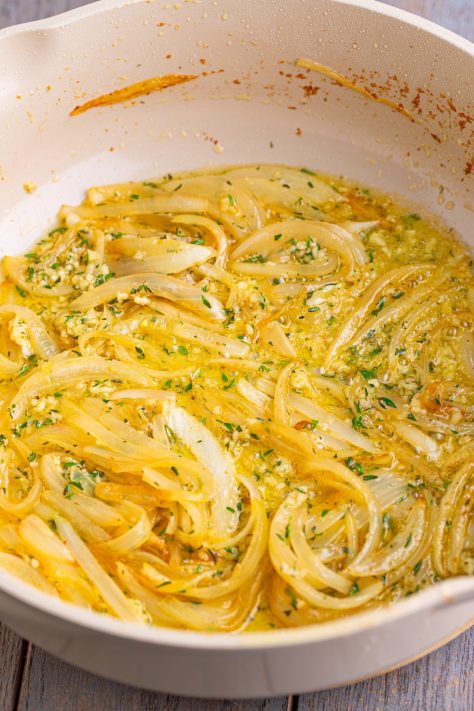Butter and onion in a skillet cooking.