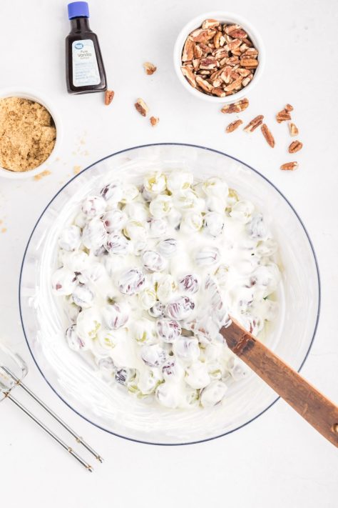 A bowl of grapes with a creamy mixture.