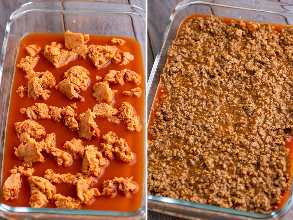 A baking dish with enchilada sauce and clumps of refried beans. 