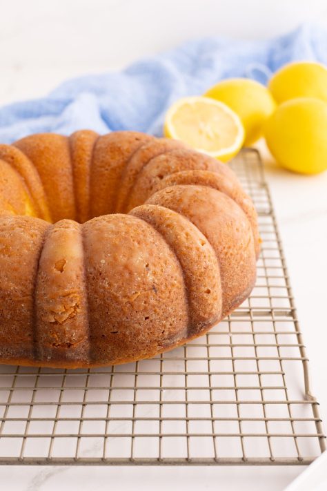 A bundt cake cooling on a wire rack.