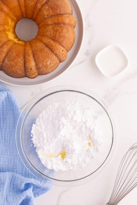 Lemon glaze being made in a bowl.