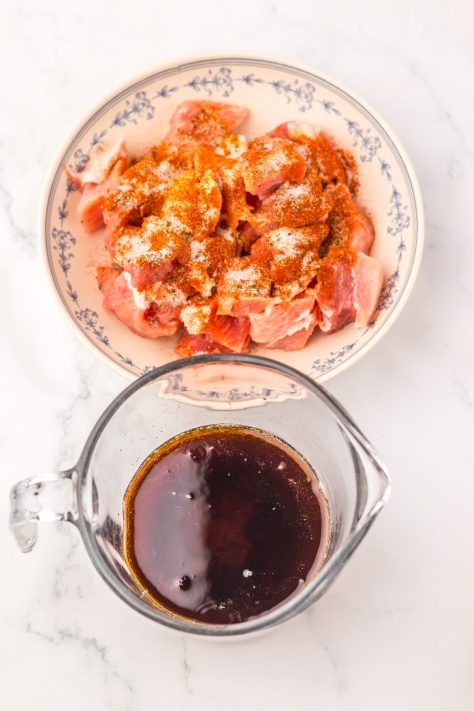 A bowl of seasoned meat and sauce being made.