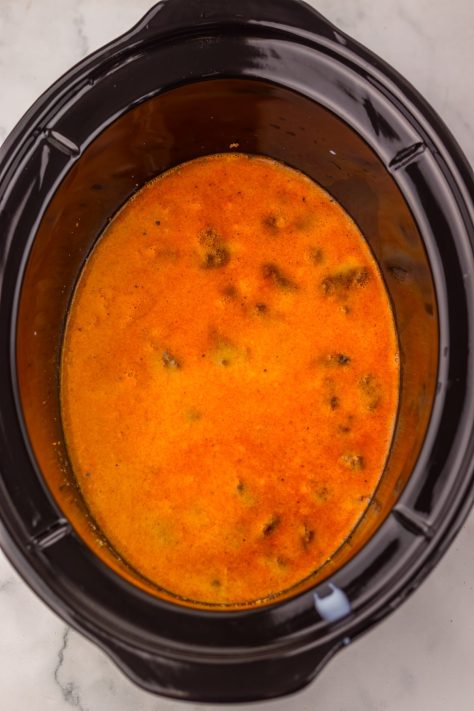 Beef and sauce cooking in a Slow Cooker.