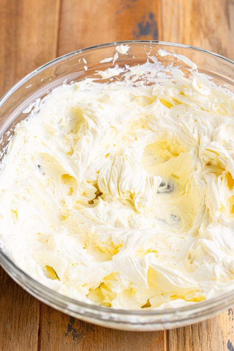 Cream cheese being whipped in a bowl.