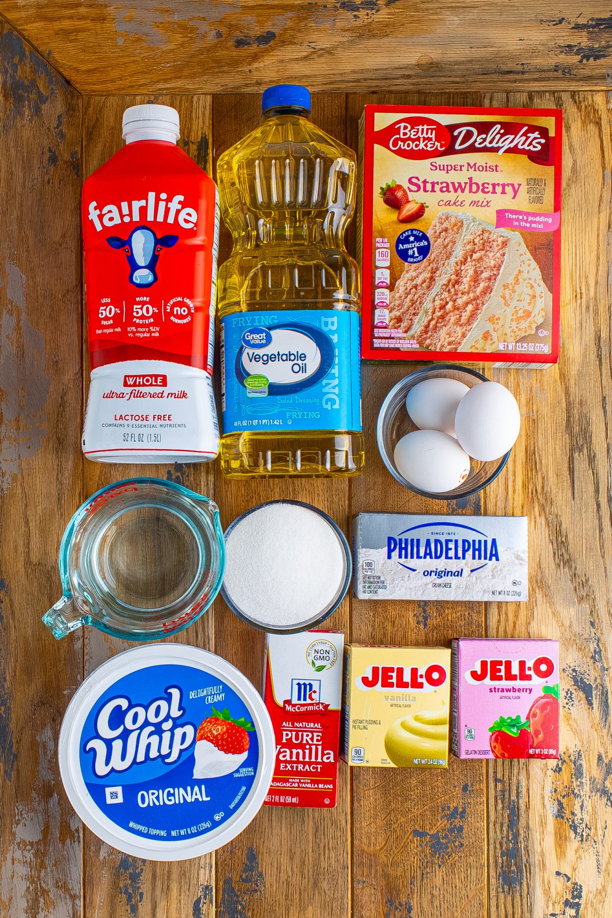 Strawberry cake mix, egg, oil, cream cheese, eggs, granulated sugar, vanilla extract, cold milk, instant vanilla pudding mix, strawberry gelatin mix, and whipped topping.