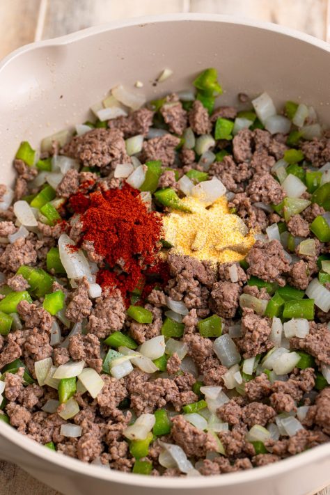 Spices added to ground beef, onions, and peppers.
