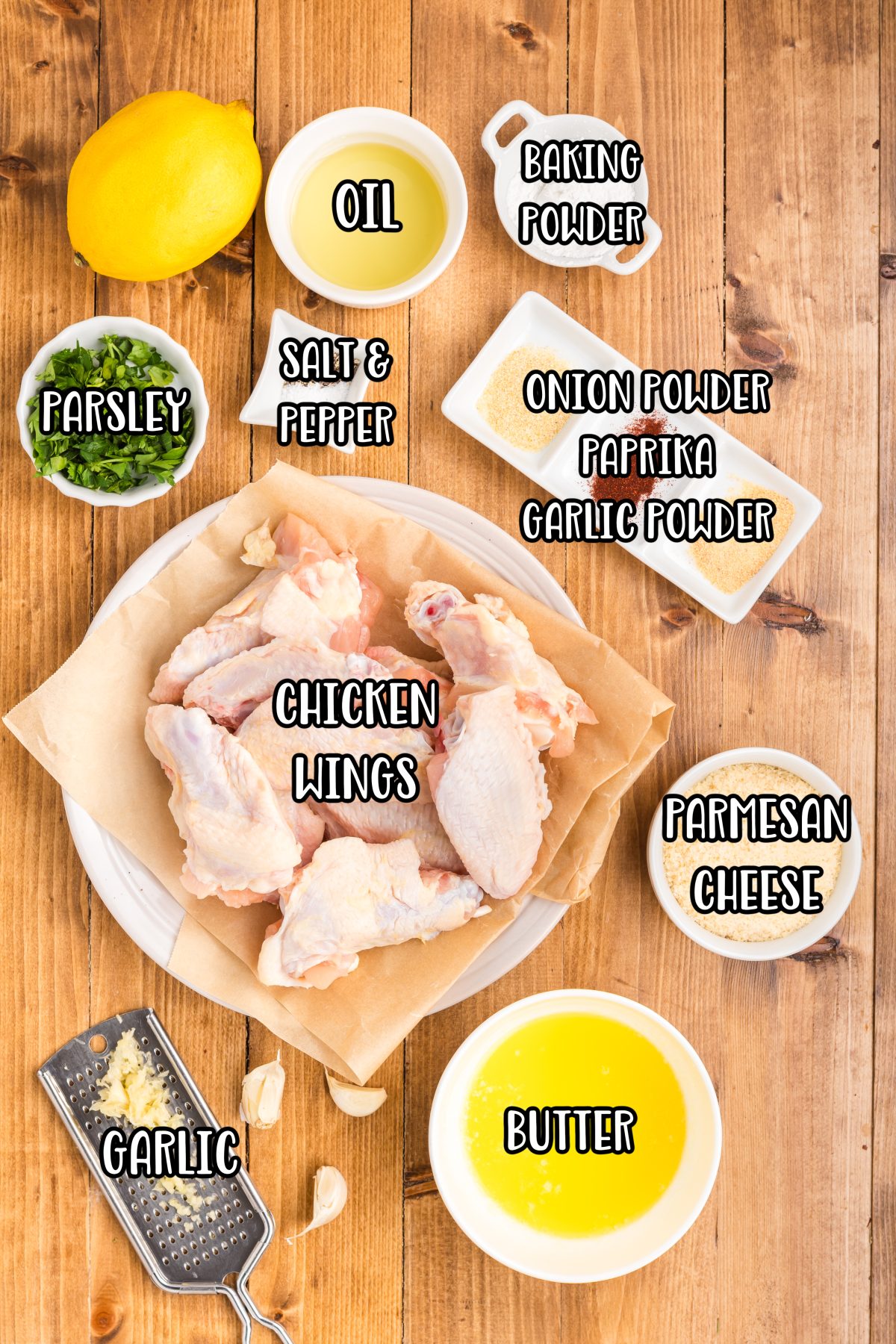 Chicken wings, oil, fresh lemon juice, baking powder, garlic powder, onion powder, kosher salt, pepper, paprika, butter, parsley, Parmesan cheese, and garlic.