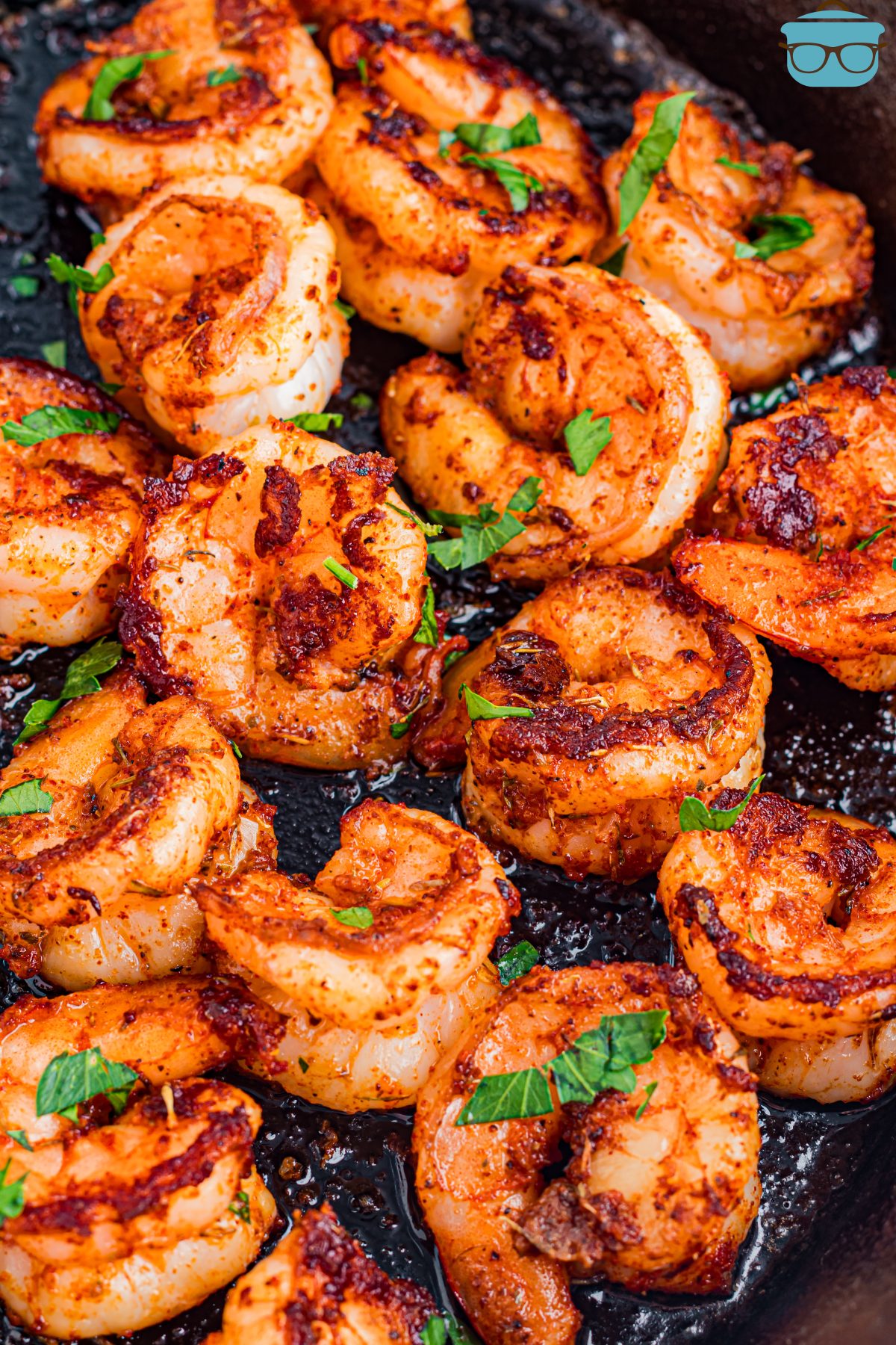 A few dozen Blackened Shrimp with garnishes.