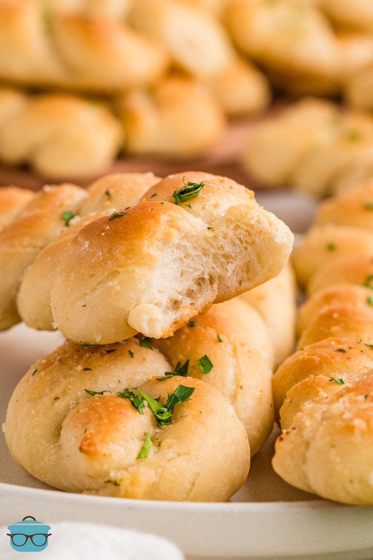 A few Braided Breadsticks, one with a bite missing.