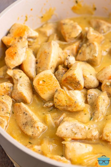Looking down on a skillet with Chicken Bites in Gravy.